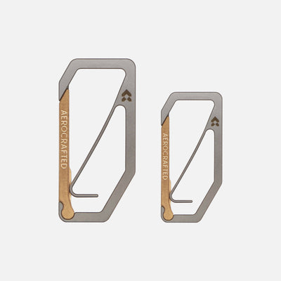 Two EDC carabiners made out of titanium and bronze and is called the Uplock Key Carabiners made by Aerocrafted, one larger and one smaller