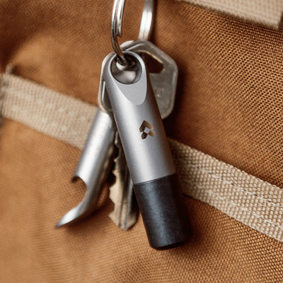 high end minimalist keychain that is a pill and cash stash made of Ultem and Titanium #material_titanium-ultem