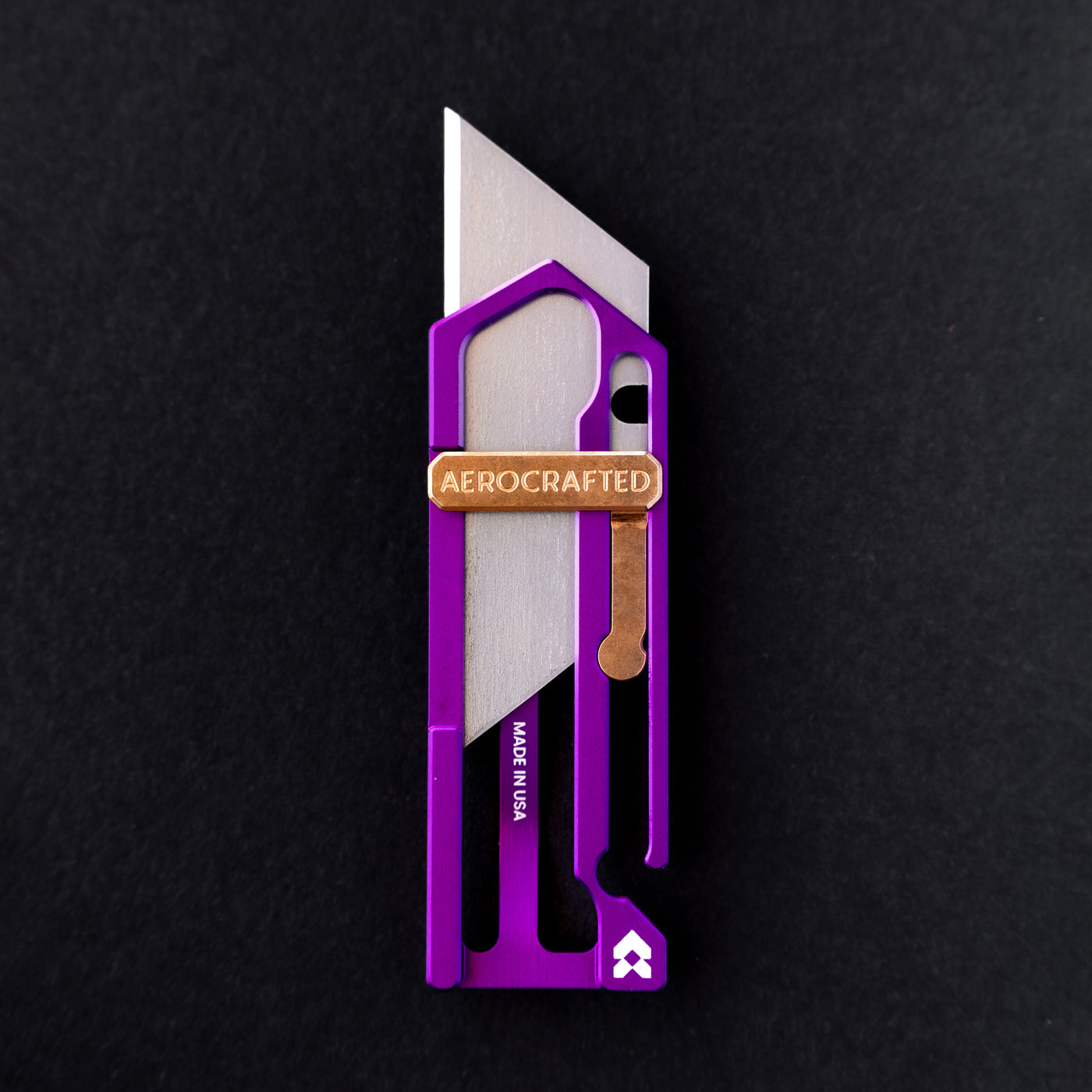 vibrant and cool utility knife designed by aerocrafted #material_ultraviolet-aluminum-bronze