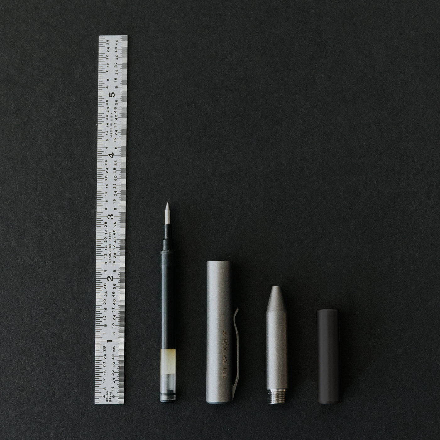 The contrail pocket pen showing all four parts of the titanium edc pockpen dissasembled showing the pen is smaller than four inches and made in the usa #material_titanium-ultem