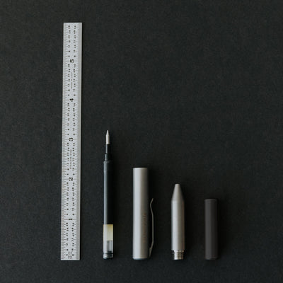 The contrail pocket pen showing all four parts of the titanium edc pockpen dissasembled showing the pen is smaller than four inches and made in the usa #material_titanium-ultem