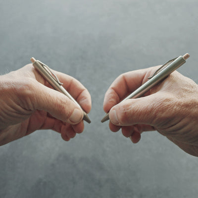 two titanium pens options have the same click pen mechanism but holds different ink cartridge refills the smallest holds a G2 mini and the larger a full parker refill #material_titanium-bronze