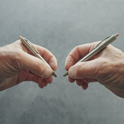 two titanium pens options have the same click pen mechanism but holds different ink cartridge refills the smallest holds a G2 mini and the larger a full parker refill #material_titanium-bronze