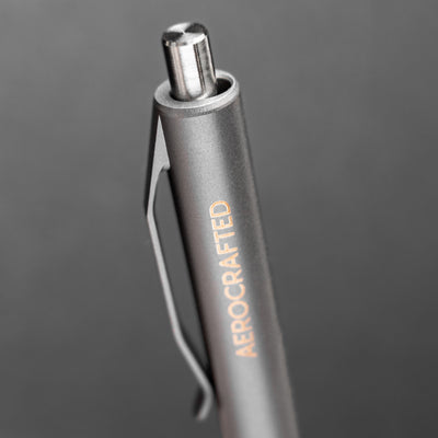 An EDC click pen with a stainless steel clicker is a titanium click pen called the retract made and machined in the USA #material_titanium-stainless