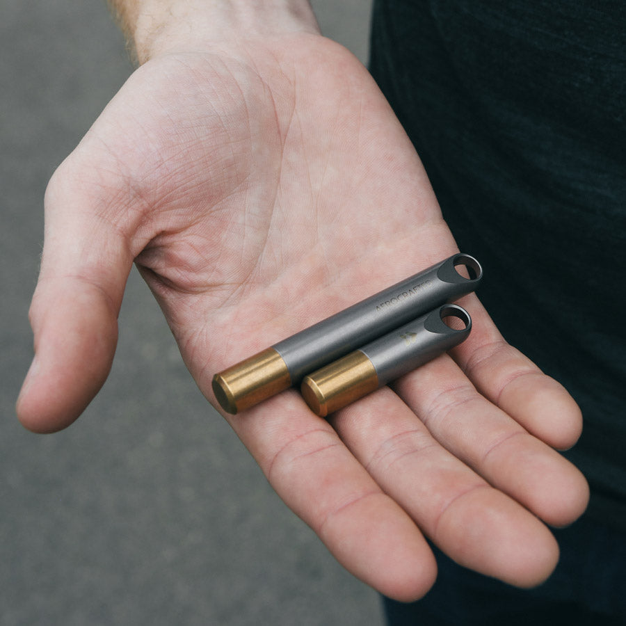 titanium edc stash in two sizes fits toothpicks and pills made out of titanium and bronze and is a fairing keychain stash #material_titanium-bronze