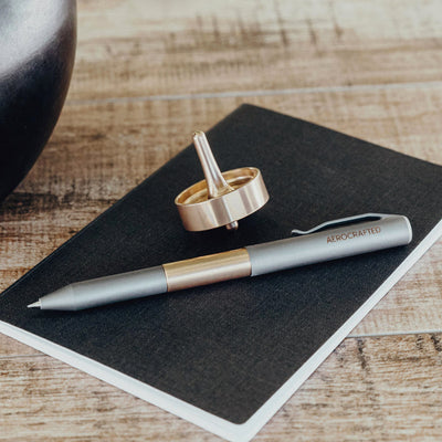 bronze top and minimal pen on journal #material_bronze