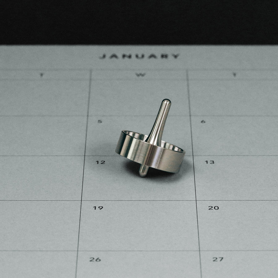 titanium fiddle toy top on desk calendar #material_titanium