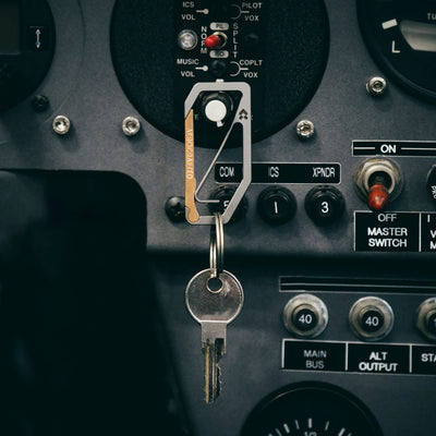 aerocrafted uplock key edc carabiner is made out of titanium and bronze hanging with a keyring attached to the keychain carabiner is designed by aerospace engineers and made in the usa #material_titanium-bronze