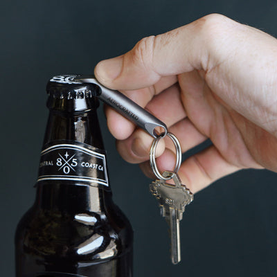 The wingman titanium bottle opener is an edc bottle opener made to fit on a key ring and assist in opening bottles and can be used as a tiny pry bar